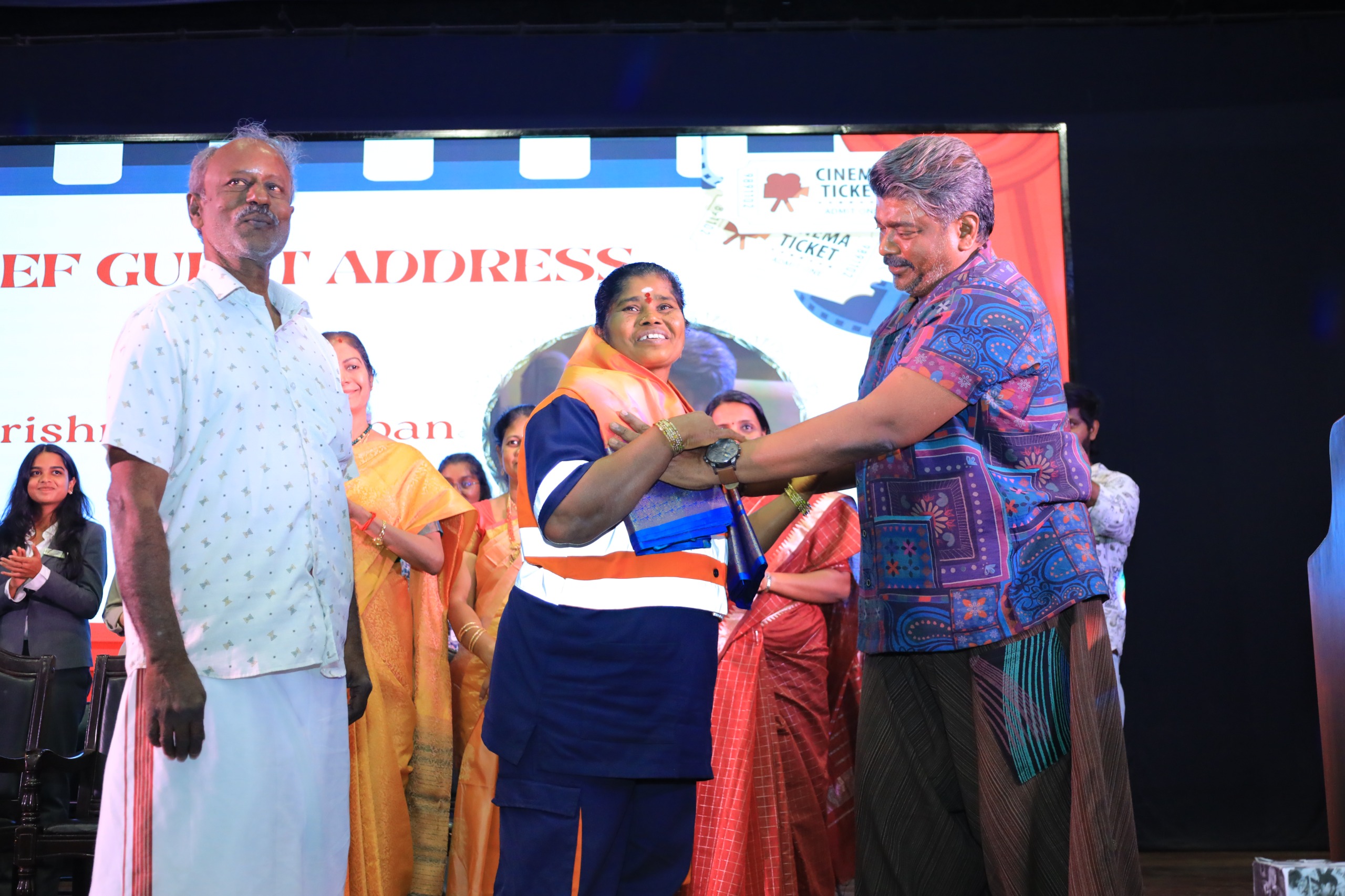 Radhakrishnan Parthiban invites sanitation worker Padma to Ethiraj College and honours her